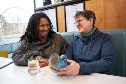 LGBTQ+ couple chatting over coffee