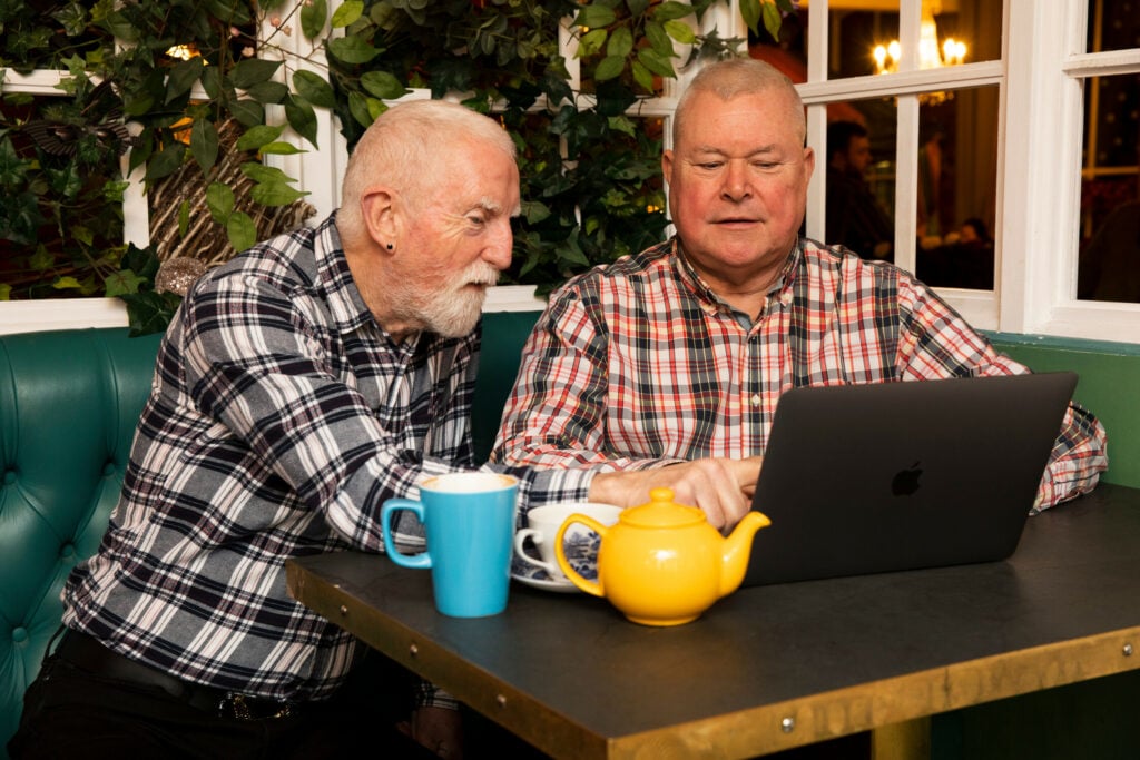 LGBTQ+ couple using a laptop together