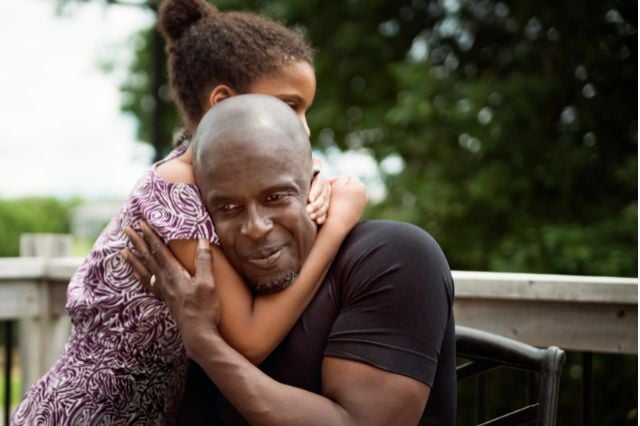 close up of man hugging someone