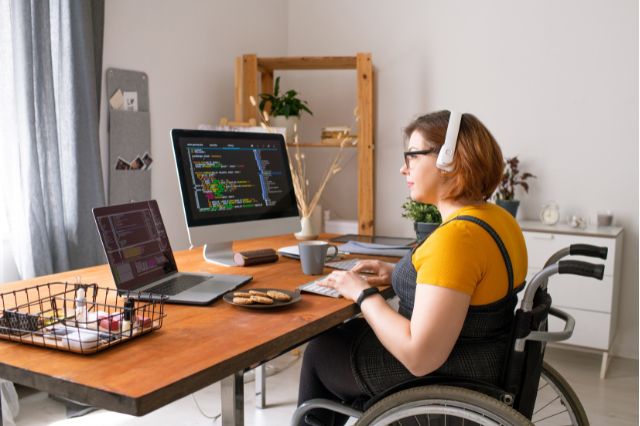 woman in wheelchair at desk