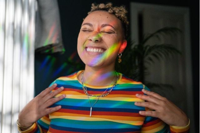 rainbow dressed person smiling