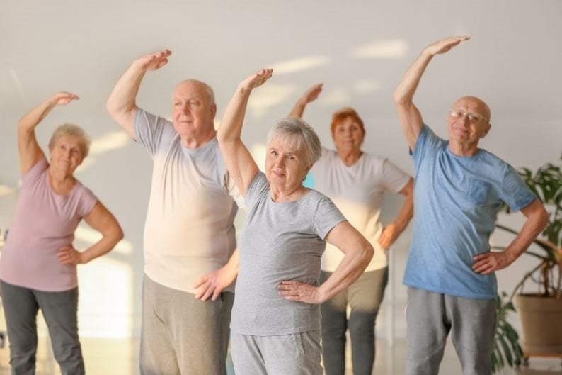 Older people stretching in a class